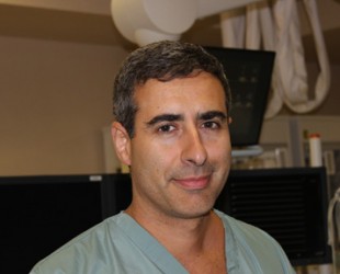 Dr. Neil Fam, cardiologist, in catheterization lab